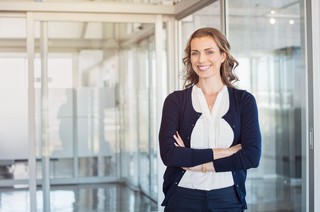 Portrait of mature beautiful business woman in the office lookin